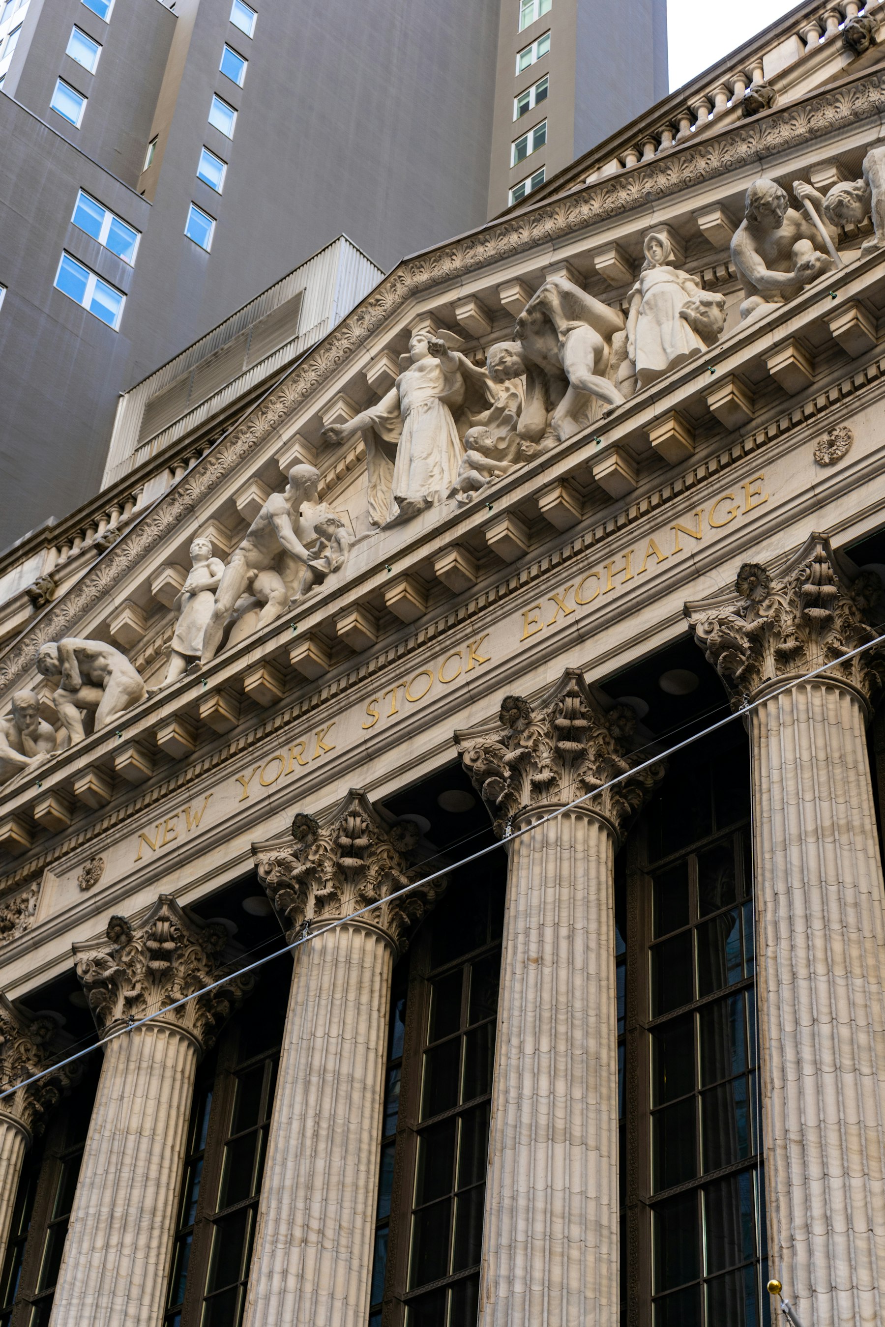 Stock exchange facade with stone columns and institutional ornament. Photo from Unsplash.