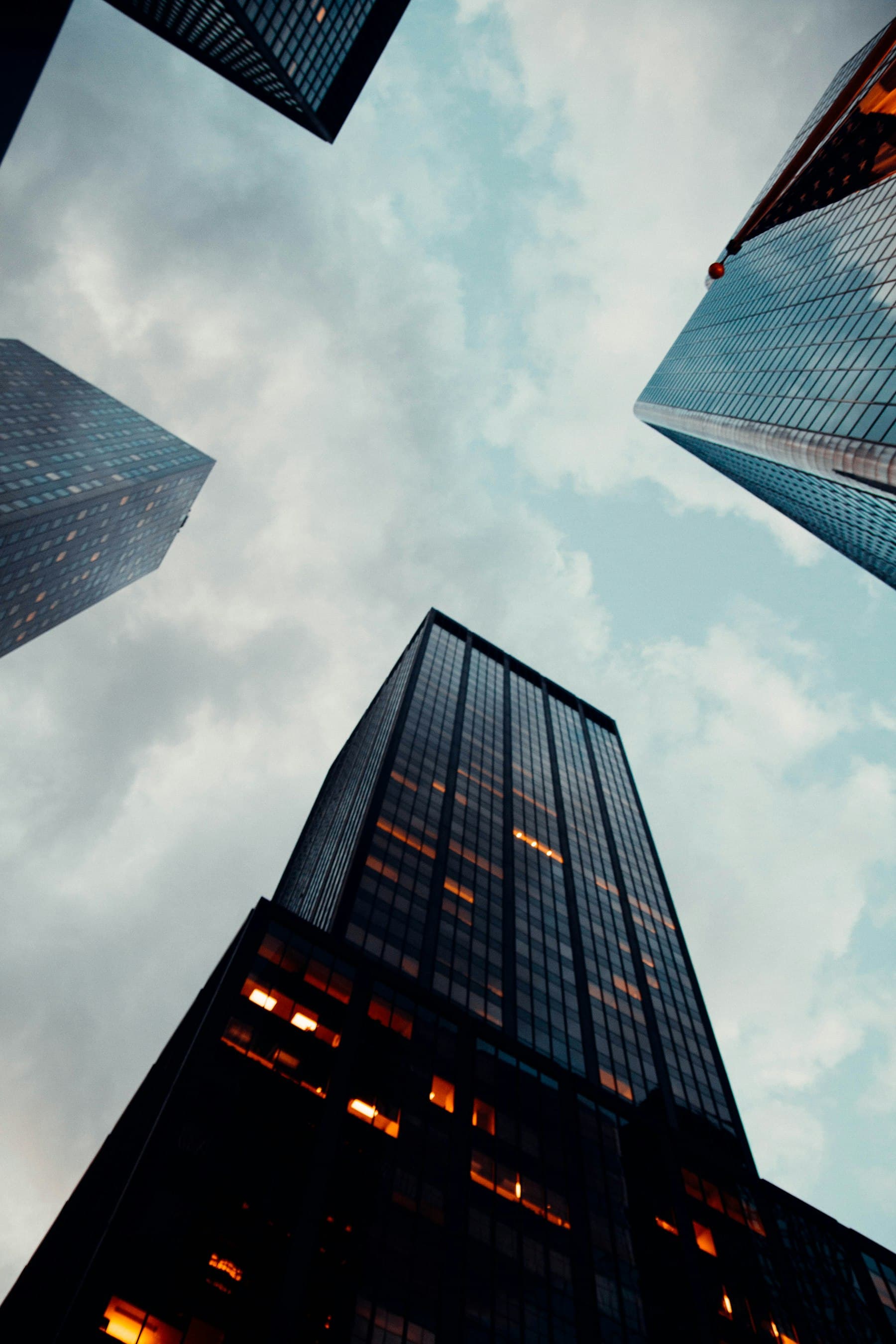 Looking upward between office towers in a financial district.
